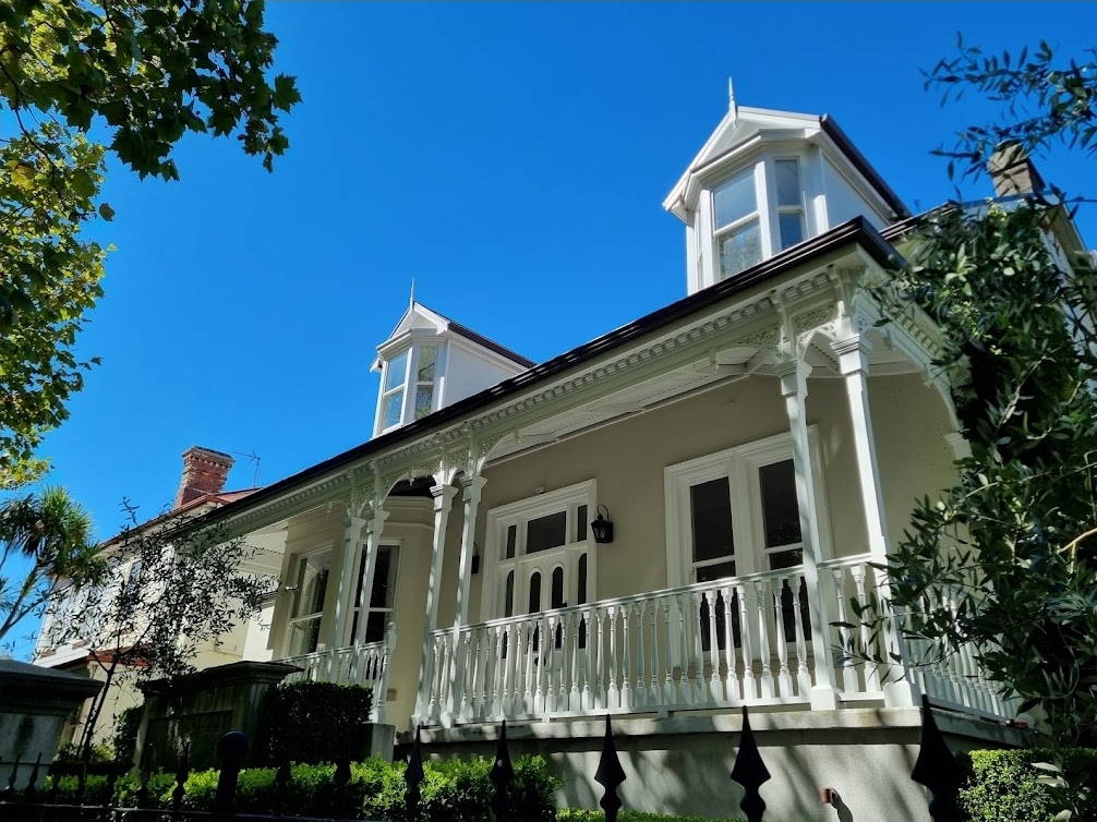 Freshly washed heritage villa in Auckland with pristine windows under a blue sky