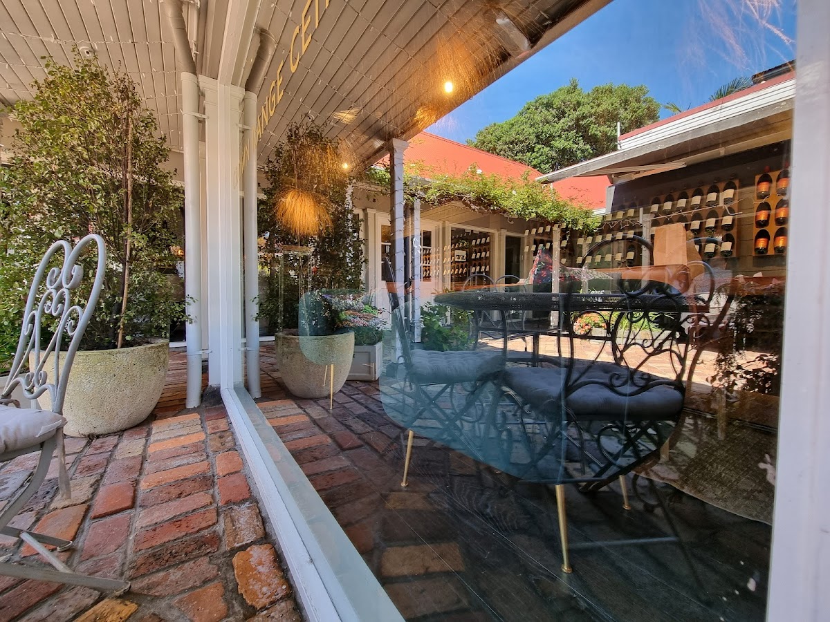 Clean heritage veranda with sparkling glass and brick paving