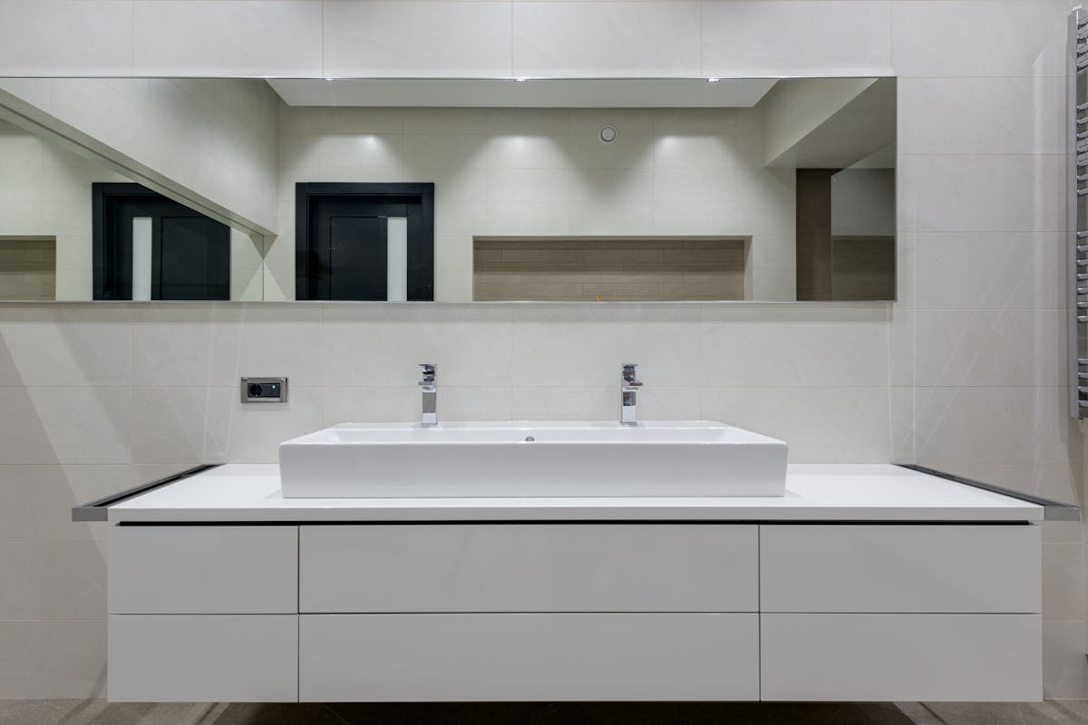 Sparkling clean bathroom mirror and glass splashback